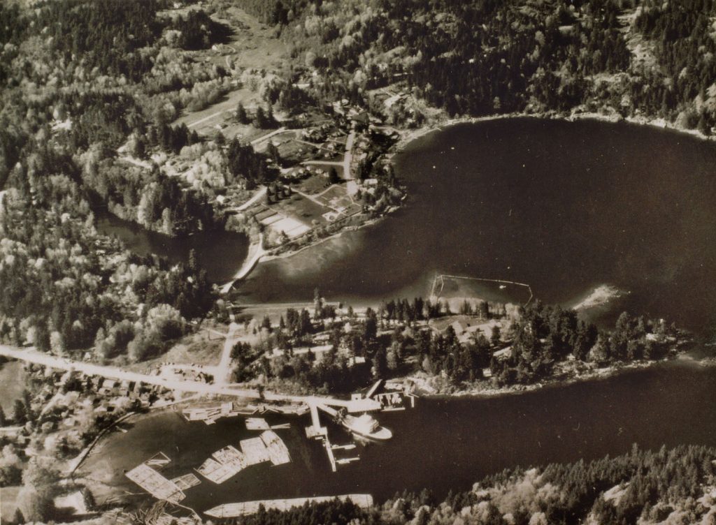 Aerial photo of Snug Cove in the thirties showing resort and log booms